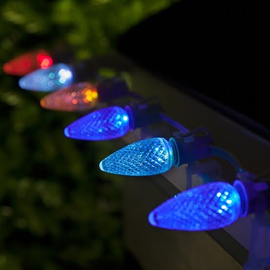 Orange and purple Halloween lights next to red and green Christmas lights.