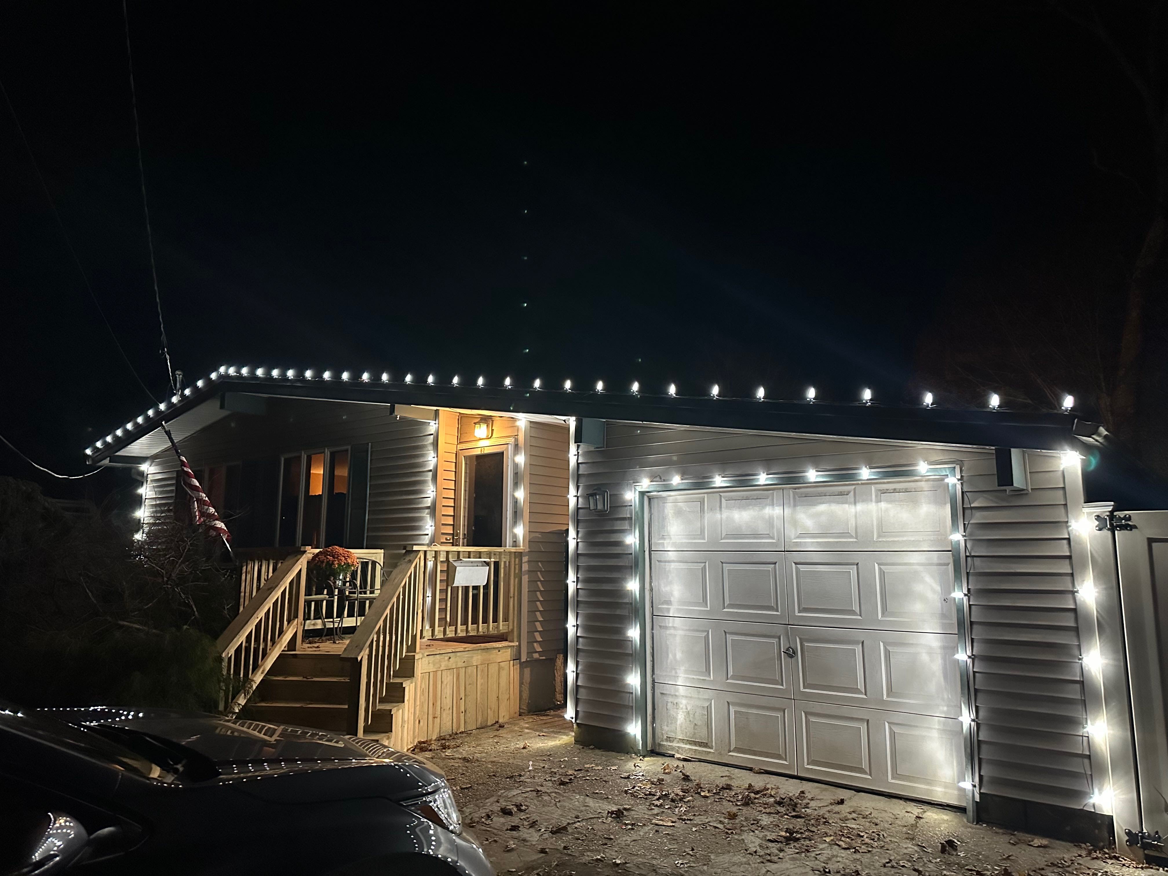 A home with beautiful custom-fit roofline holiday lighting.
