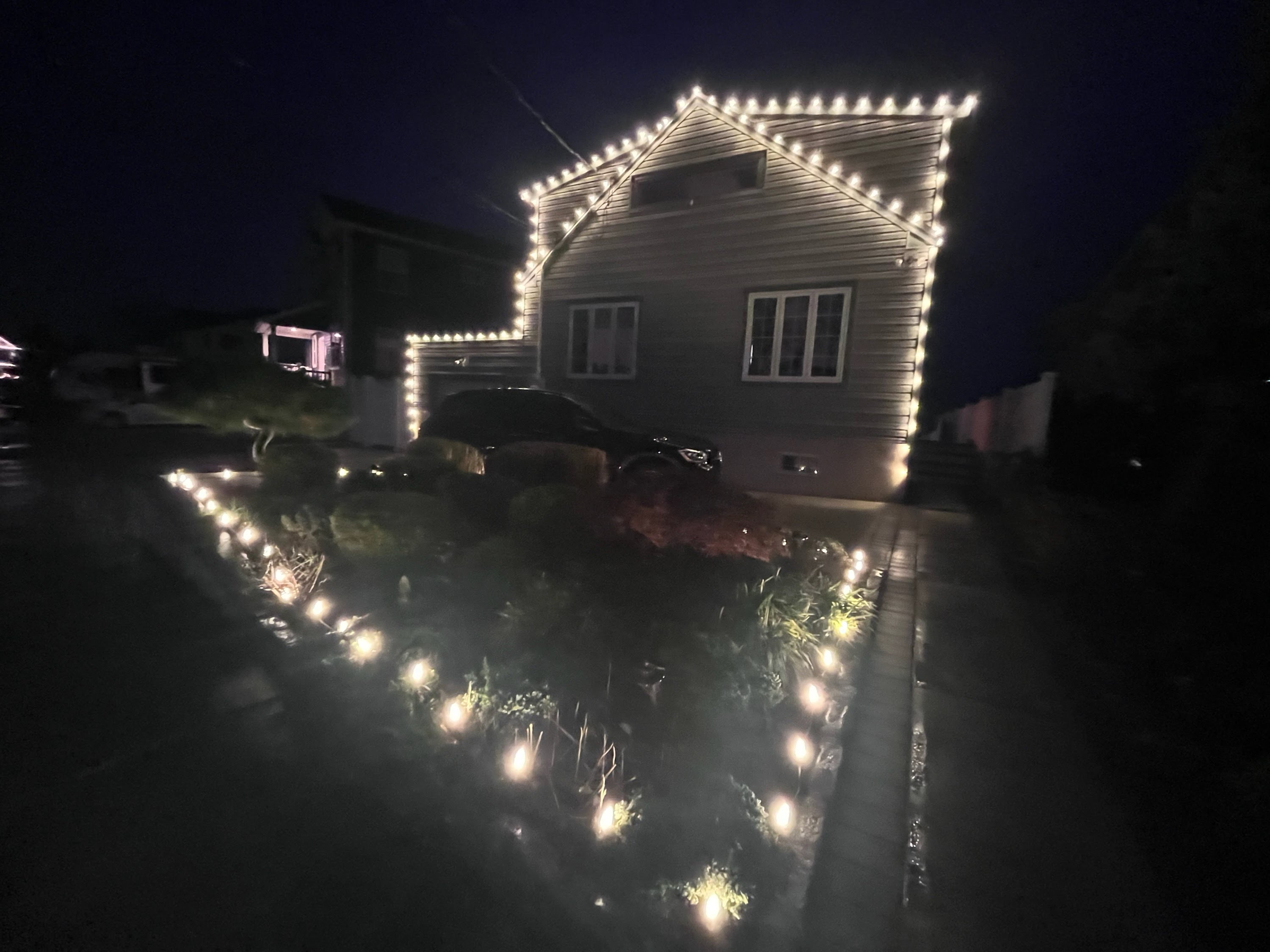 A complete holiday transformation with roofline lighting and landscape lights.